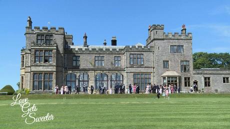 An Elegant and Stylish Lakes Wedding Video a wide shot of the stunning countryside lake district venue armathwaite hall with the wedding guests outside on the lawn