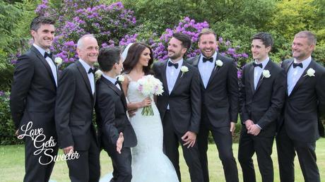 An Elegant and Stylish Lakes Wedding Video A bride and the groomsman having a fun wedding photo taken with the guys wearing classic black and white