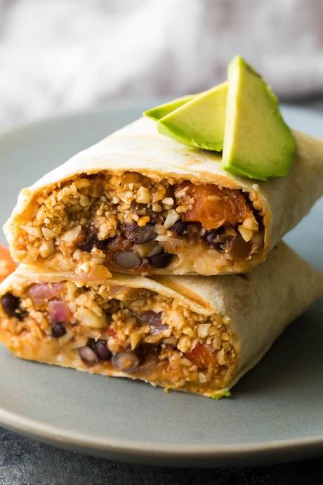 These freezer cauliflower rice black bean burritos are lighter but just as tasty! Loaded with veggies, salsa, black beans and cheese, and so convenient to have stocked in your freezer.
