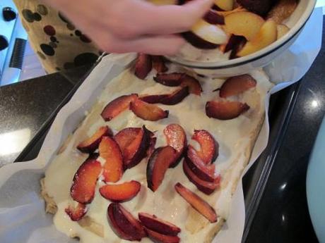 Plums being added to the slice