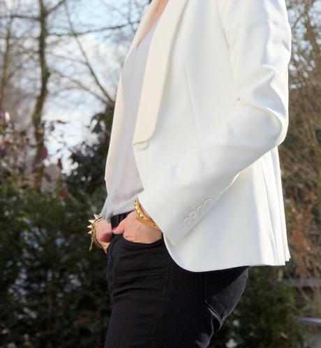 The white blazer and gold bracelets The white blazer and gold bracelets