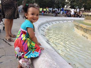 Our daughter trying to climb into a Parisian fountain