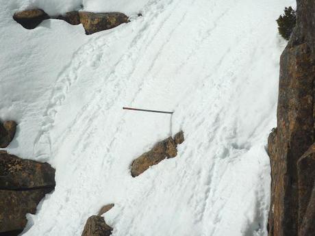 horizontal metal pole in snow beneath cradle mountain summit
