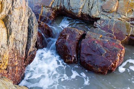 red rocks in water at gardiner point