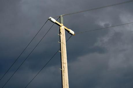 power pole with dark clouds behind