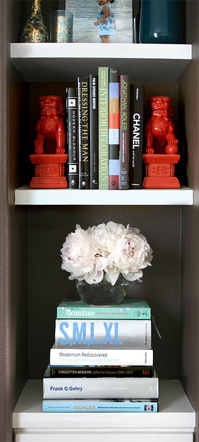 vignette: white peonies on the fireplace shelves