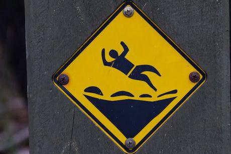 warning sign depicting man falling over