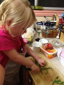 Lillian cutting beans for dinner