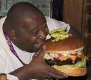 English: It is a fat African American eating a...