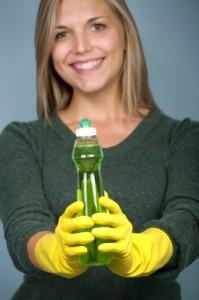 Clean the Green way! - Woman wearing rubber gloves and holding dish soap Clean the Green way! - Woman wearing rubber gloves and holding dish soap