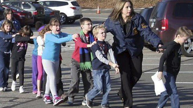State police officers lead evacuated students from the school after the shooting. Shannon Hicks (Newtown Bee)