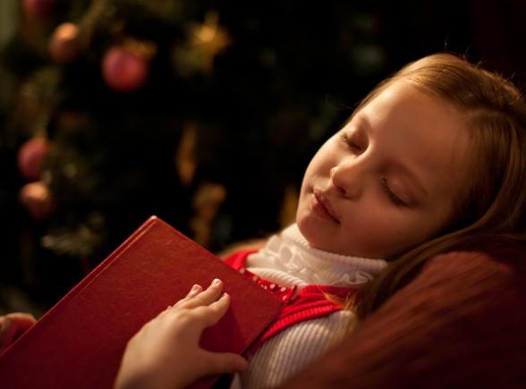 girl sleeping santa book