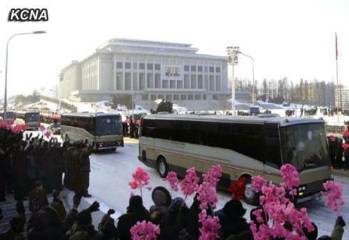 Buses containing participants in the 12 December 2012 launch of the U'nha03 rocket ride past the 25 April House of Culture in Pyongyang on 4 January 2013 (Photo: KCNA)