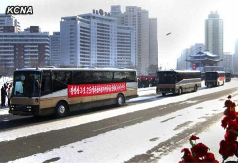 Buses transporting rocket launch personnel ride past  the Pot'ong Gate, at the intersection of Ch'angkwang and Ch'o'llima Streets in central Pyongyang on 4 January 2013 (Photo: KCNA)