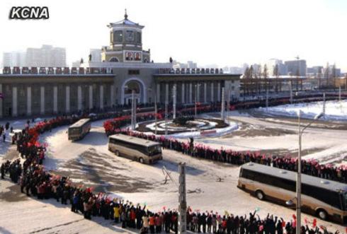 Buses carrying personnel who contributed to the 12 December 2012 U'nha-3 rocket launch ride past Pyongyang Central Railway Station prior to departing the city on 4 January 2013 (Photo: KCNA)