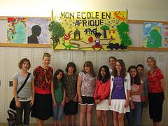 6th graders in front of their banner displayed...