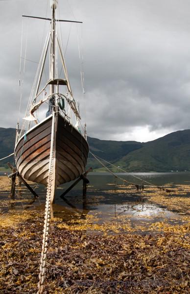Photo - an old wooden sailing boat in the bay at Ballachulish, Scotland
