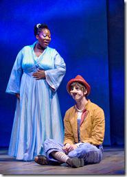 Storyteller (Melody Betts) offers guidance to Pinocchio (Sklyer Adams) during his journey in Chicago Shakespeare Theater’s world premiere musical Review: Adventures of Pinocchio (Chicago Shakespeare)