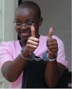 Victoire Ingabire, leader of FDU-nkingi, coming out of a Rwandan court with handcuffs.