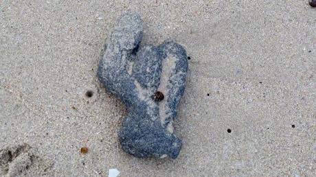 object on beach in shape of person waving