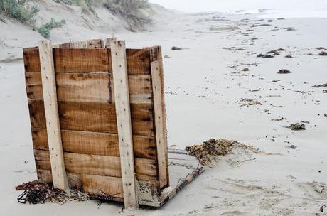 remains of wooden crate washed up on beach