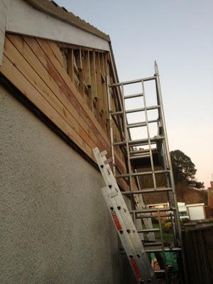 Cedar cladding being fitted to gable wall