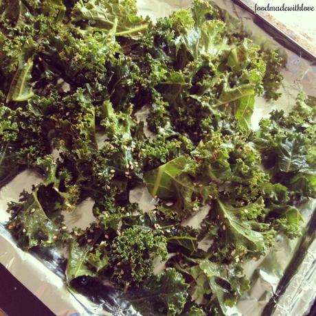 Single layer kale leaves placed on baking tray ready to be baked!