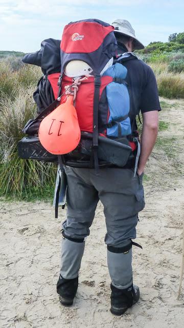 backpack with helmet, buoy and flipper strapped on exterior