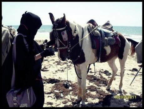 Me with a horshey at a beach in Pakistan muslim women