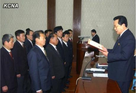 DPRK Vice Premier Kim Yong Jin (R) reads a citation at the 2013 ceremony for the 16 February Science and Technology Prize at the People's Palace of Culture in Pyongyang on 6 February 2013 (Photo: KCNA)