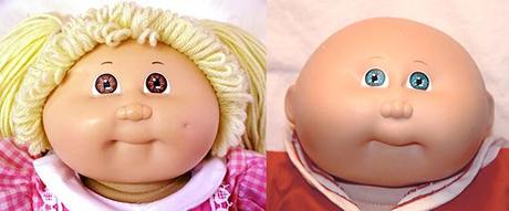 two Cabbage Patch Kids dolls, a girl and a boy with their distinctive bright eyes, fat chubby faces, tiny puckered mouths, and goofy expressions