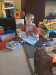 Little Mr A reading and playing