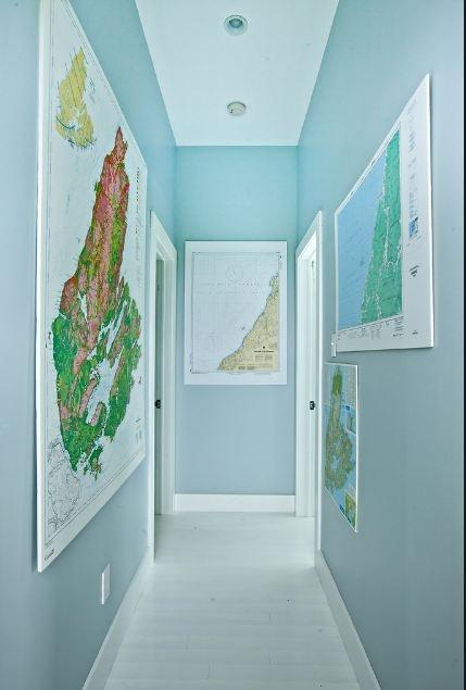 A blue hallway adorned with maps