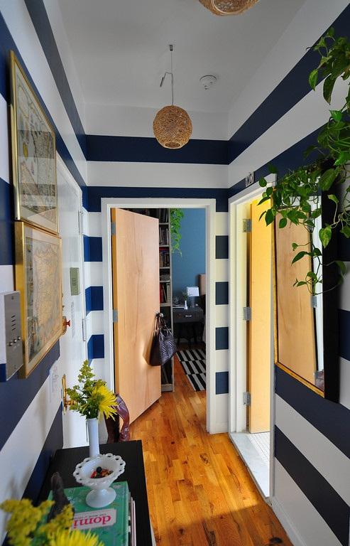 Big bold stripes from floor to ceiling contrast well with the light wood flooring. Photo from Pinterest.