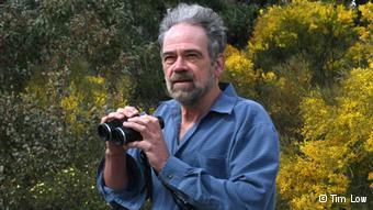 A photo of Australian biologist Tim Low with binoculars 