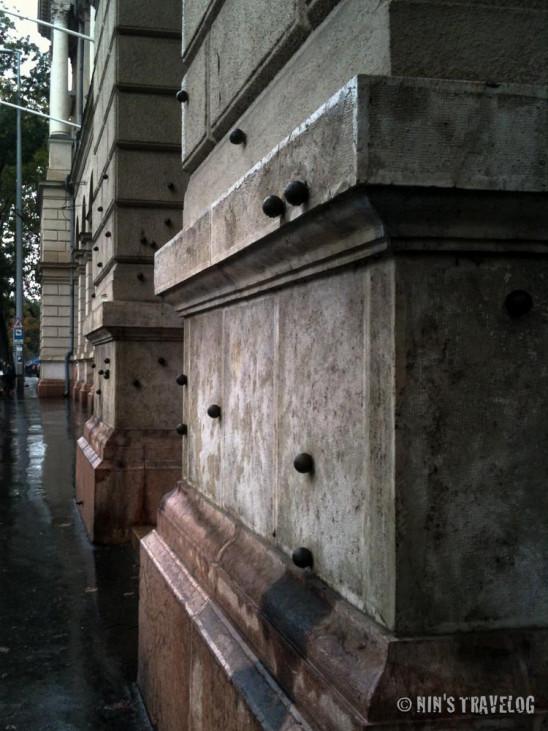 Budapest’s Architecture In memory of the uprising, bullet decoration stuck on the museum in one of the building around the 'town square'