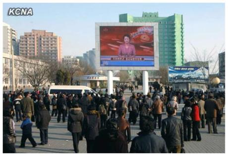 DPRK citizens watch a KCTV anchorwoman read a statement of the KPA Supreme Command on a jumbotron outside Pyongyang Central Railway Station on 26 March 2013 (Photo: KCNA)