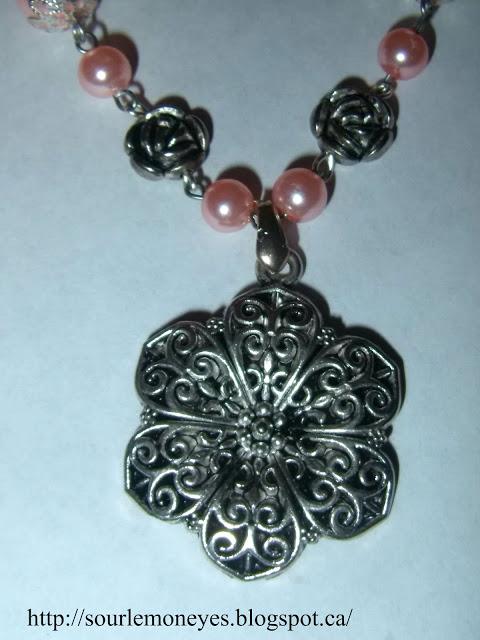 pink pearl necklace with silver roses and a silver flower pendant  