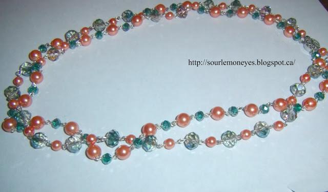 peach colored faux pearl necklace with blue and teal crystal beads