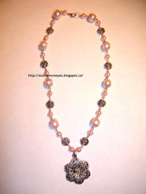 pink pearl necklace with silver roses and a silver flower pendant  