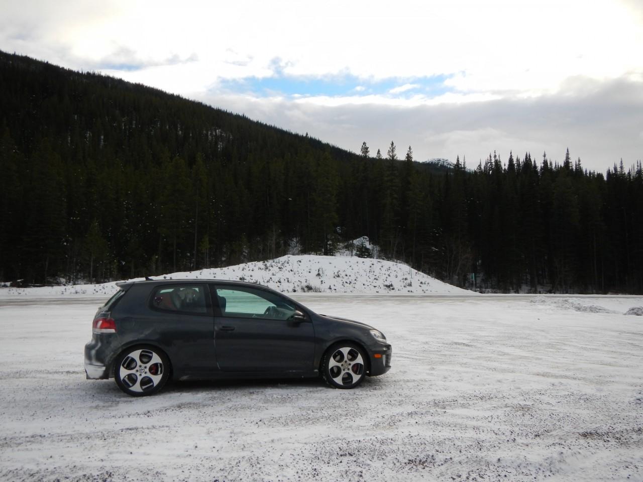 VW GTI parked lakeside in the snow