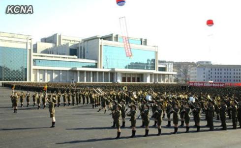 The all-woman brass band of the Korean People's Internal Security Forces play a musical programme during the 14 April 2013 unveiling ceremony.  In the background is the Ponghwa Art Theater.  (Photo: KCNA)