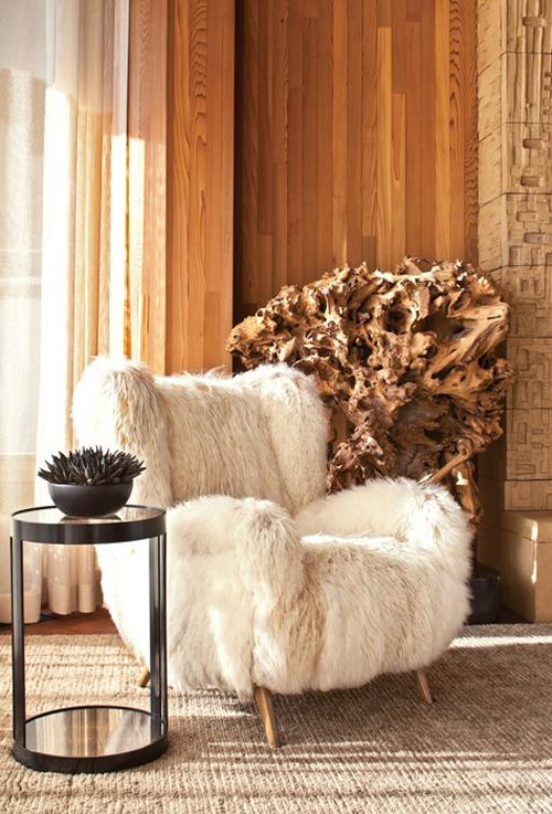Kelly Wearstler beach house living room wood paneling fur covered chair driftwood