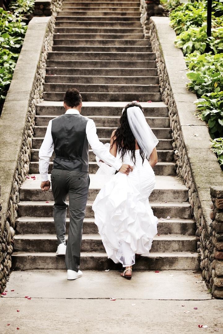 Bride and Groom Walking Up Stairs