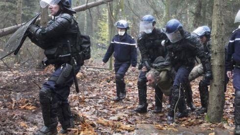 This Nov. 24, 2012 file photo shows French gendarmes detaining a protester during an evacuation operation on land that will become the new airport in Notre-Dame-des-Landes, western France. An unlikely alliance of anarchists and beret-wearing farmers is creating a headache for President Francois Hollande’s beleaguered government by mounting an escalating Occupy Wall Street-style battle that has delayed construction on the ambitious airport near the city of Nantes for months. (AP Photo/Laetitia Notarianni, File) (The Associated Press) 
