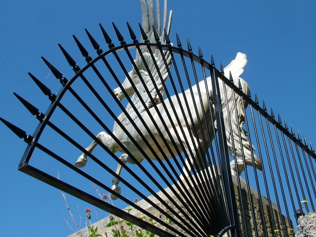 Powerscourt House and Gardens, A World Of Floral Glory – Ireland Winged Horse statue through fence - Powerscourt - Ireland