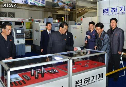 DPRK Cabinet Premier Pak Pong Ju (1) is briefed about the Ryonha Machinery Company's exhibition at the 16th annual Pyongyang Spring International Trade Fair at the Three Revolutions Exhibition in Pyongyang. (Photo: KCNA)