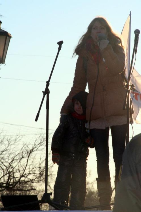 (Maria addresses a protest rally with son at her side.)