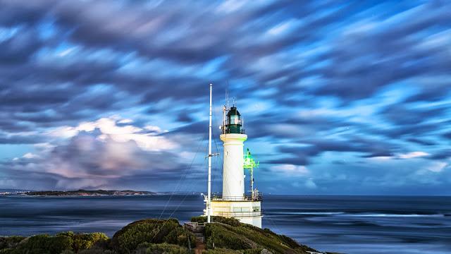 point lonsdale lighthouse and port phillip heads with moving clouds