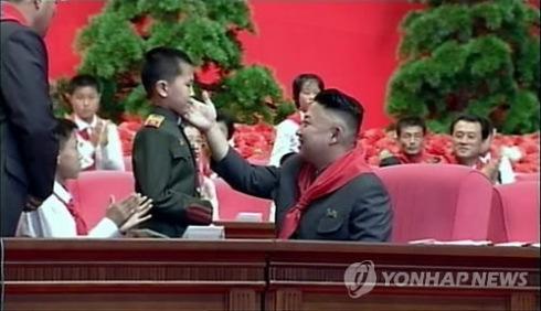 Kim Jong Un attends greets a member of the Korean Children's Union (KCU) during the KCU's 7th Congress held at 25 April House of Culture in Pyongyang on 6 June 2013 (Photo: KCTV-Yonhap)